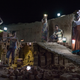 Workers use solar lamps to collect newly baked bricks at night in Saipur, India.
